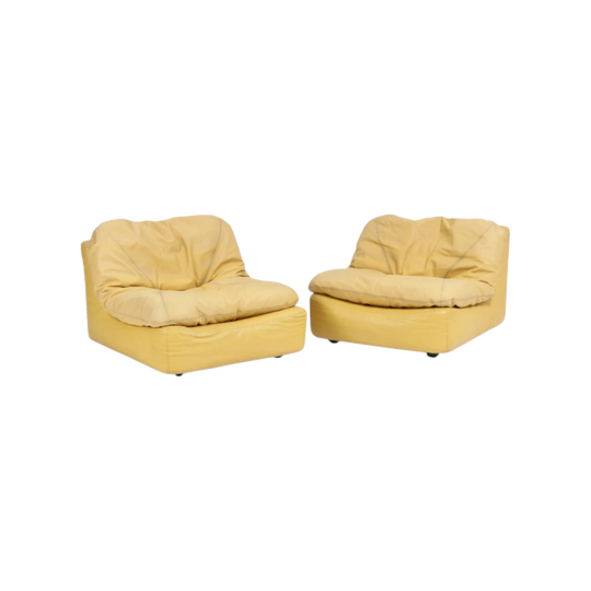 A pair of lounge chairs upholstered with yellow coloured leather. 1970–80's.
