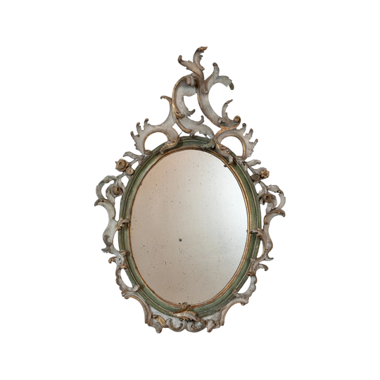 An Italian Rococo Carved, Painted and Parcel-Gilt Oval Mirror