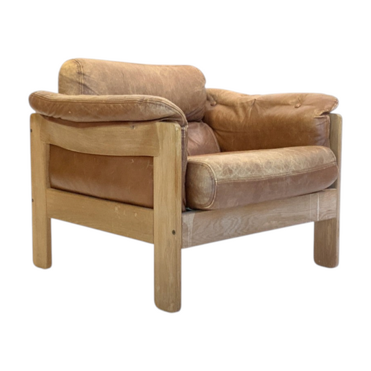 Illum Wikkelso Oak and Leather Lounge Chair. Pair available, priced individually.