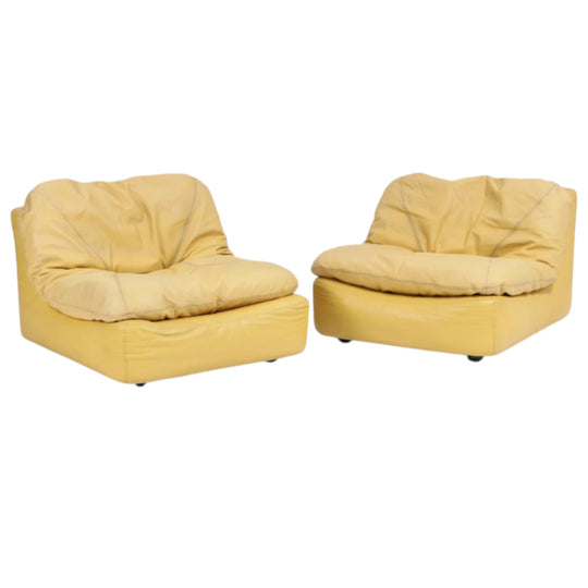 A pair of lounge chairs upholstered with yellow coloured leather. 1970–80's.