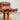 A rare set of 4 vintage Joe Rufenacht lounge chairs with Howe leather upholstery and curved wooden frames are arranged on a light gray floor against a plain white background.