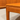 Close-up of a wooden table corner with smooth, rounded edges and visible wood grain. In the background, a rare set of Alpa Teak Nesting Tables (set of 3) highlights Australian Mid-Century Modern design from Revive.