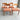 A set of four fully restored THB 'Milan' dining chairs (Rediscover), crafted from Tasmanian blackwood with curved backs and muted orange upholstered seats, arranged in two rows on a concrete floor against a plain wall.