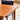 Close-up of the Fully Restored Parker 140 Square Extension Table (Rediscover) with rounded edges and a smooth finish, set indoors near a concrete floor, in front of a black cushioned chair by a window or doorway.