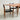Fully Restored Parker 140 Square Extension Table (Rediscover) with two matching wood chairs featuring black leather seats and backs, set on a light gray concrete floor against a light gray wall.