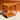 The Mid-Century Noblett Drinks Trolley – Removable Tray & Original Castors (Revive) features rounded edges and two teak shelves, standing on a sunlit concrete floor in front of matching wood cabinetry.