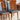 Close-up of restored Noblett T-back dining chair highlighting the signature open back and teak timber