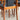Close-up of NEW IN! Fully Restored Noblett T-Back 'Boston' Dining Chairs Set of 4 in black vinyl. The warm teak and padded seats highlight the natural grain and classic mid-century modern style, all arranged on a light-colored floor.