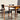 Two wooden chairs with black seats and backs from the Vintage Parker Dining Suite 5 Piece Square - Number 140 sit next to a matching table. Sunlight highlights the mid-century, Scandinavian-inspired Australian design.