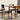 Two wooden chairs with black seats and backs from the Vintage Parker Dining Suite 5 Piece Square - Number 140 sit next to a matching table. Sunlight highlights the mid-century, Scandinavian-inspired Australian design.