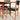 The Vintage Parker Dining Suite 5 Piece Square - Number 140 (Refine) features wooden chairs with black seats and backs beside a matching table. Sunlight casts sharp shadows, emphasizing its minimalist, Scandinavian-inspired Australian style.