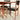 The Vintage Parker Dining Suite 5 Piece Square - Number 140 (Refine) features wooden chairs with black seats and backs beside a matching table. Sunlight casts sharp shadows, emphasizing its minimalist, Scandinavian-inspired Australian style.