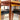The Vintage Parker Dining Suite 5 Piece Square - Number 140 features four black-seated chairs arranged around a matching table, with sunlight highlighting the warm wood grain in this Scandinavian-inspired Australian design.