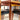The Vintage Parker Dining Suite 5 Piece Square - Number 140 features four black-seated chairs arranged around a matching table, with sunlight highlighting the warm wood grain in this Scandinavian-inspired Australian design.