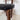 Detail of the fitted seat rails and vertical supports on a Danish mid‑century teak chair by Peter Hvidt.