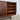 Right side of Danish modern rosewood sideboard with open door.