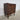Side angle of Danish rosewood chest of drawers with tapered legs and solid edges.