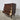 Side angle of Danish rosewood chest of drawers with tapered legs and solid edges. Showing open drawers