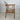 Side profile of Sven Åge Eriksen GM11 chair with curved teak armrest and upholstered cushions.