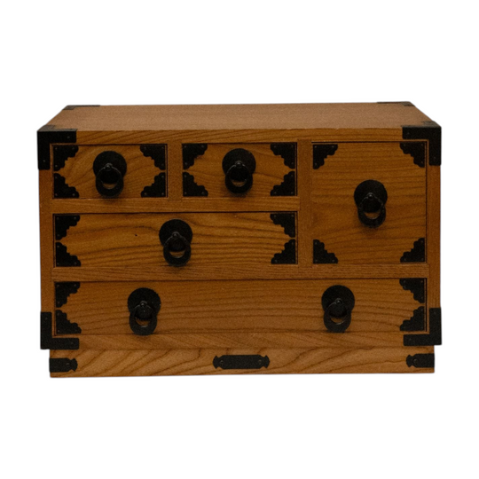 Japanese wooden chest of drawers lined with yellow fabric
