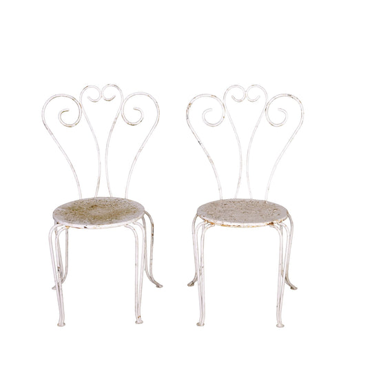Pair of Vintage French outdoor wrought iron armchairs with a white patina