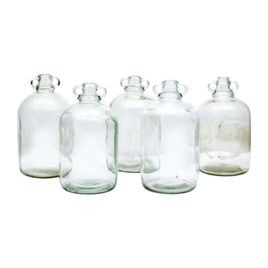 A collection of five clear glass cider bottles English Circa 1900