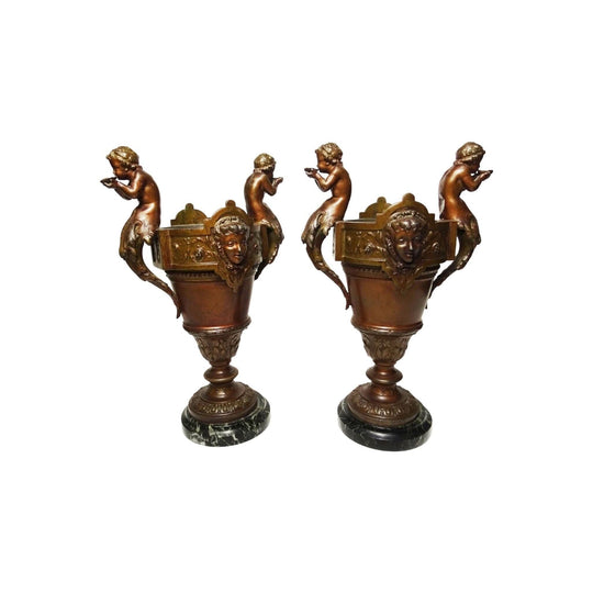 A pair of antique French patinated bronze cherub putti vases