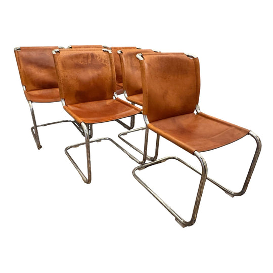 A rare 1970s Italian set in the style of Marcel Breuer — six sculptural cantilever chairs in polished chrome and 5 mm tan leather.