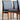 A set of four professionally restored Parker 118 Slab Back Chairs with black upholstered seats and wooden frames is displayed on a concrete floor against a light, textured wall. Pre-order available with a 25% non-refundable deposit.