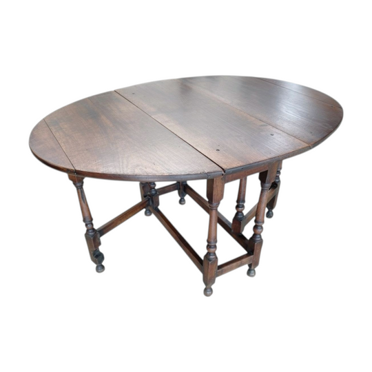 A mid 18th century oak drop-side table.