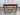 Front view showing the rectangular top and teak base of the side table.