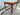 Reverse three-quarter view of the teak base and tapered legs.