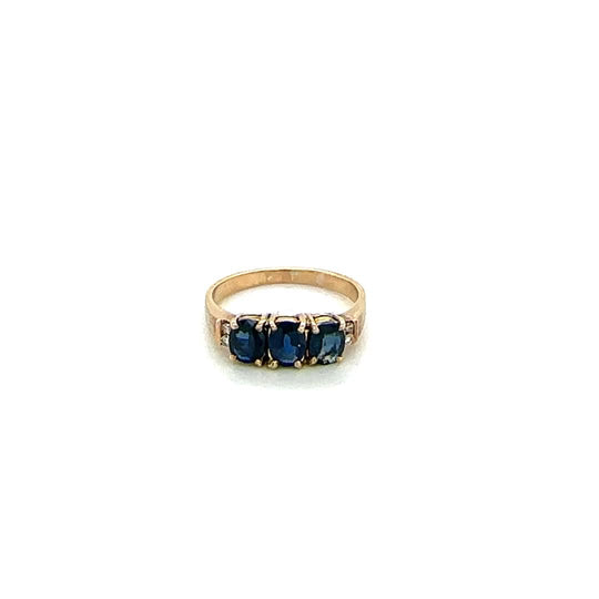 Three stone deep blue sapphire and diamond ring