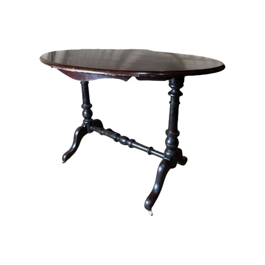 Victorian dark stained kauri pine oval table with porcelain castors, c.1860