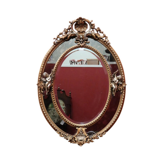 Vintage French Giltwood Oval Cushion Mirror with Silver‑Toned Cherubs and Rococo Gold Leaf