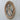 Angled view showing the depth and open scrollwork of the oval gold-tone portrait frame.