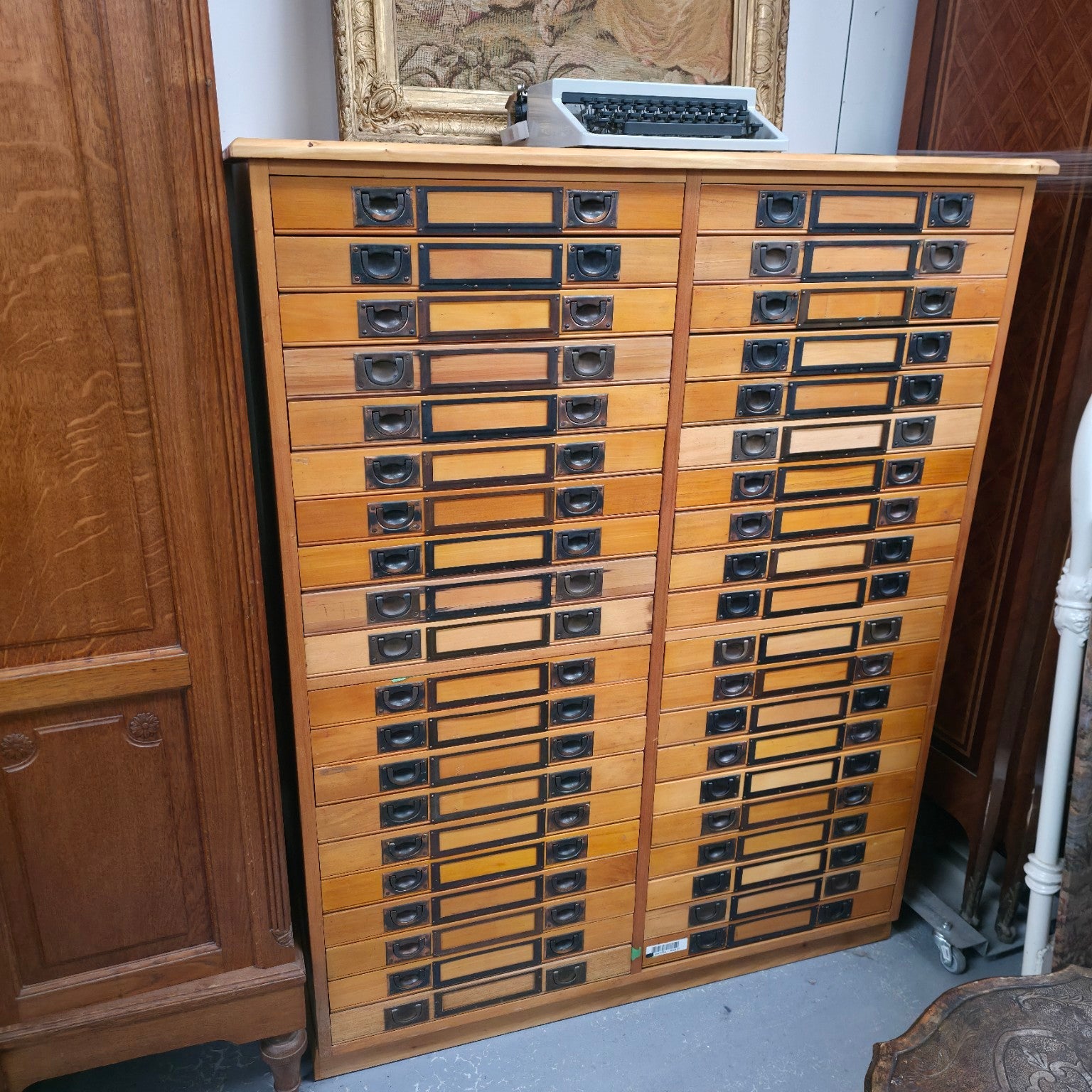 Full view of a vintage timber specimen cabinet with forty glass-topped drawers