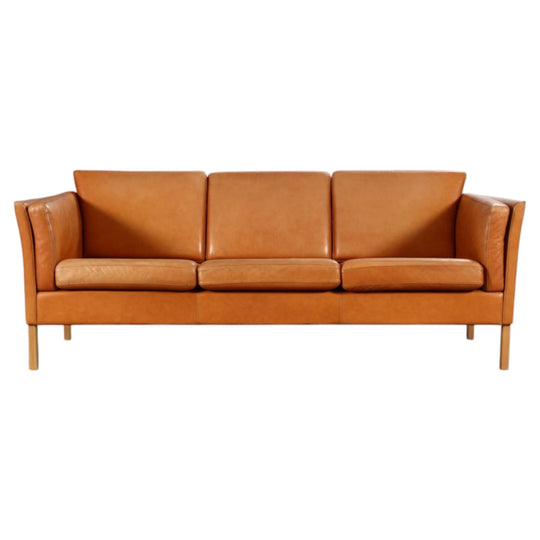 Danish furniture manufacturer. Three-seater sofa, cognac colored leather